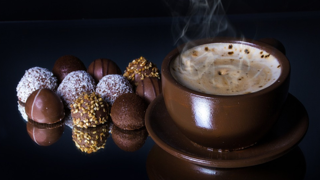 Hot coffee with assorted chocolate truffles