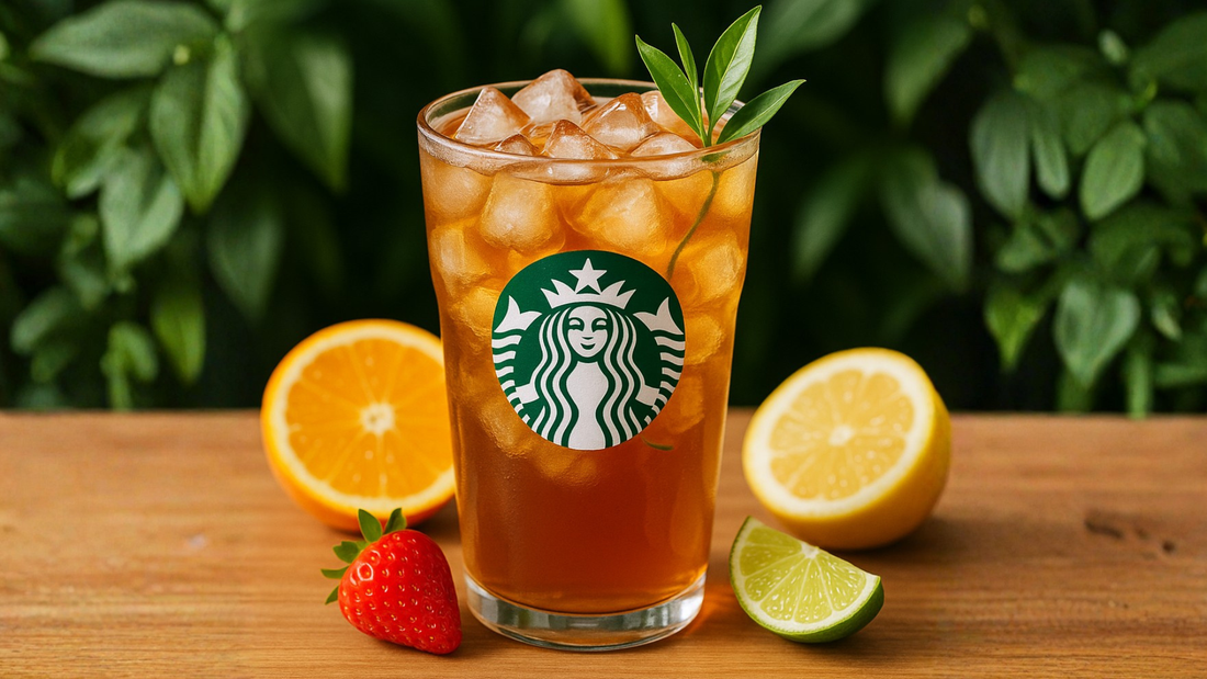 Glass of iced tea with ice, citrus fruits, strawberry, and fresh tea leaves on a wooden table